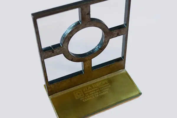 IFLA Europe award trophy recognising excellence in landscape architecture, featuring a distinctive geometric metal sculpture on a glass base.